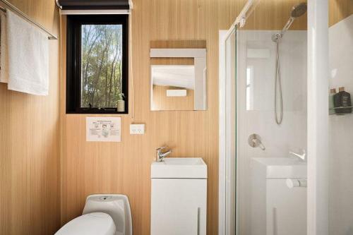 a small bathroom with a toilet and a sink at Van Demears Escapes by Tiny Away in Tamborine