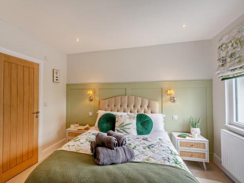 a bedroom with a large bed with two towels on it at 3 Bed in Morfa Nefyn 95040 in Morfa Nefyn