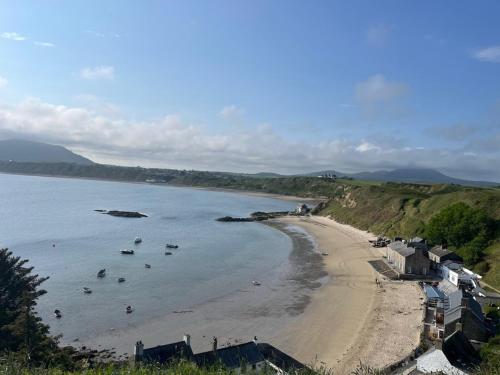 a view of a beach with boats in the water at 3 Bed in Morfa Nefyn 95040 in Morfa Nefyn