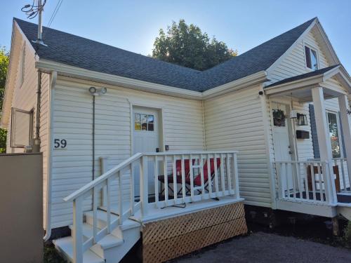 a small house with a porch and a staircase at Dream room in Moncton