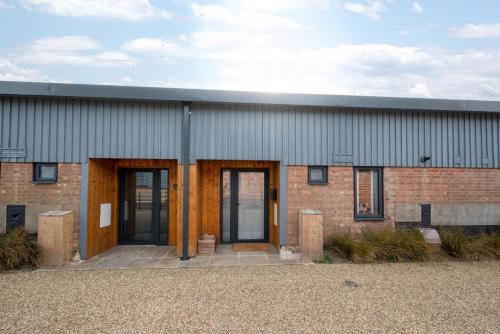a brick building with two doors on the side at No.3 Long Barn in Wangford