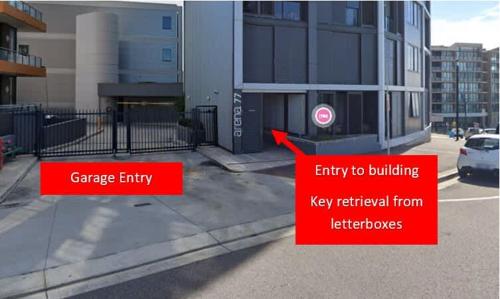 a street with two red signs next to a building at 803 - Stylish Retreat - Special Rates Through Dec 2025 in Newcastle