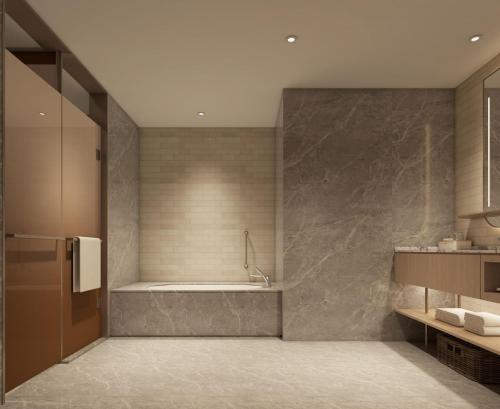 a bathroom with a tub and a sink at Hilton Garden Inn Songyuan Ningjiang in Songyuan