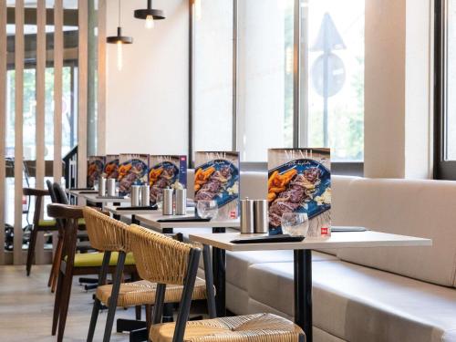 a row of tables and chairs in a restaurant at ibis Paris Alesia Montparnasse in Paris