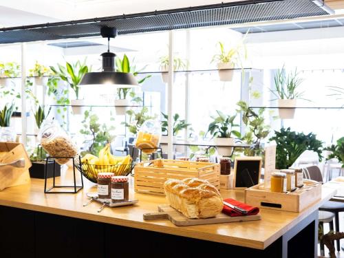 a counter with bread and other items on it at ibis Bordeaux Centre Meriadeck in Bordeaux