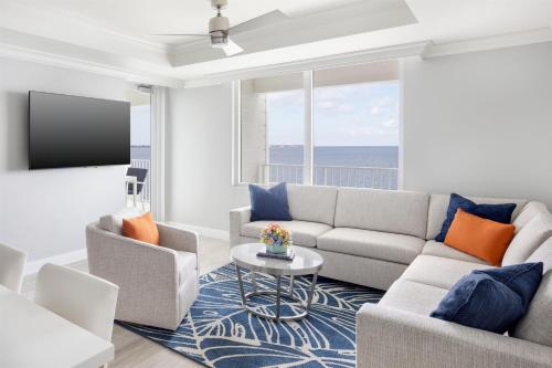 a living room with a couch and a tv at Sunseeker Resort Florida Gulf Coast, Curio Collection Hilton in Port Charlotte
