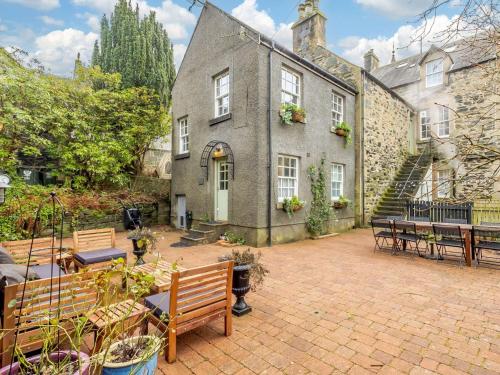 a house with benches and tables in front of it at 5 Bed in Dunkeld 90844 in Birnam