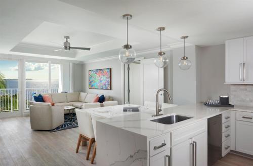 a kitchen and living room with a couch and a table at Sunseeker Resort Florida Gulf Coast, Curio Collection Hilton in Port Charlotte