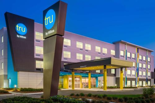 a hotel with a sign in front of a building at Tru By Hilton Savannah Airport in Savannah