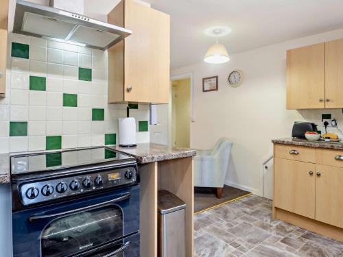a kitchen with a stove and a counter top at 1 Bed in Wymondham 43278 in Wymondham