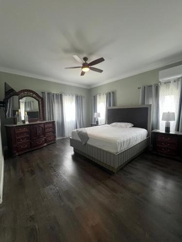 a bedroom with a bed and a ceiling fan at Tropical Palm Townhouse in Nassau