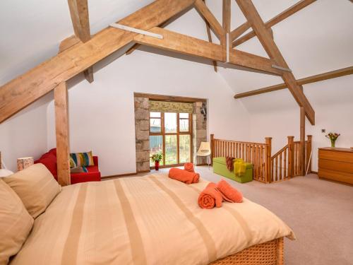a bedroom with a large bed in a room at 5 Bed in Dartmoor National Park 73264 in North Tawton