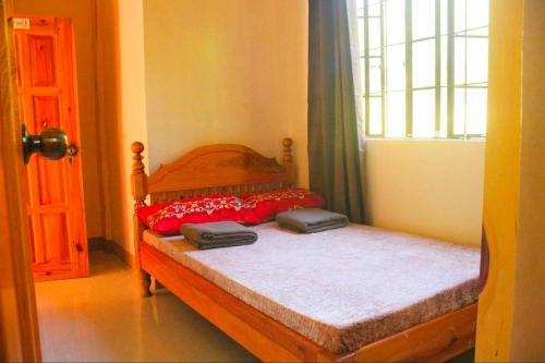 a bedroom with a bed with two suitcases on it at SAGADA STAYCATION WITH OWN PRIVATE TOILET and BATH in Sampong