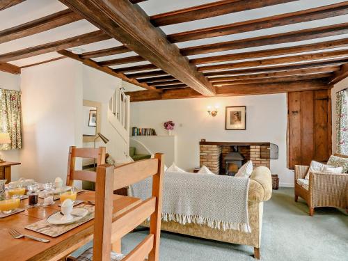 a living room with a table and a fireplace at 2 bed property in Gresham 75916 in Aylmerton