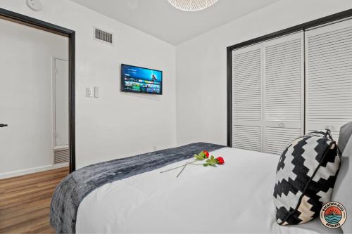 a bedroom with a bed with a tv on the wall at Spacious and Stylish 5BR with Pool plus Guest House in La Mesa