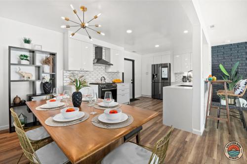 a kitchen and dining room with a wooden table and chairs at Spacious and Stylish 5BR with Pool plus Guest House in La Mesa