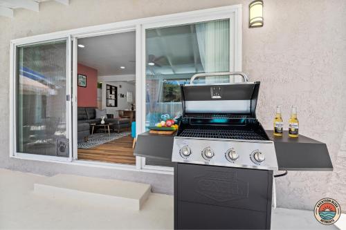 a kitchen with a stove with a view of a living room at Spacious and Stylish 5BR with Pool plus Guest House in La Mesa