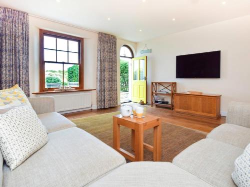 a living room with two couches and a flat screen tv at 4 bed property in Instow Devon 59699 in Instow