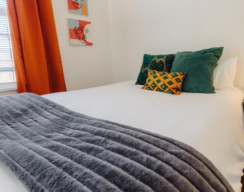 a bed with two pillows on top of it at Historic Revival 2BR Midtown Memphis Fast Wifi Free Parking Yes Pets in Memphis