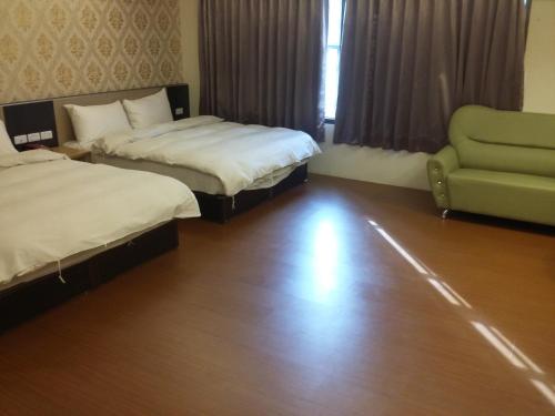 מיטה או מיטות בחדר ב-KD Hotel