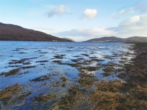 a large body of water with mountains in the background at 3 Bed in Broadford 81181 in Luib