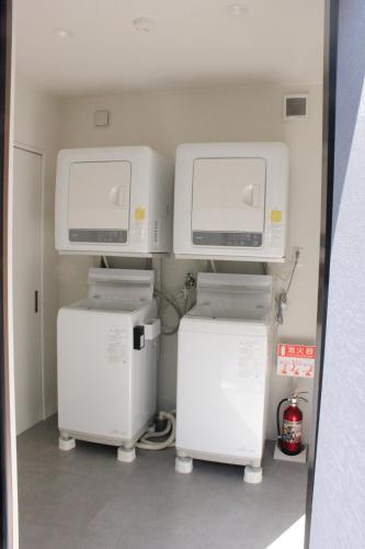 two washers and dryers in a hospital room at Chari3 in Hikone