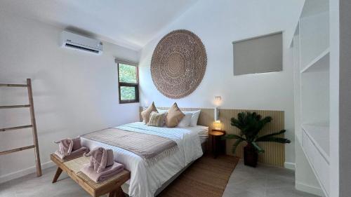 a bedroom with a bed and a potted plant at Villa Sun, Villa 19 in Chaweng Noi Beach