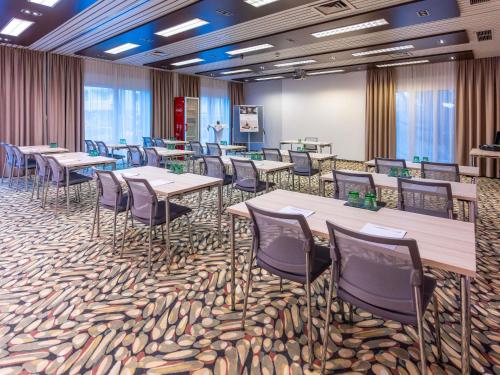 a conference room with tables and chairs on a carpet at Mercure Salzburg City in Salzburg