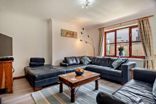 a living room with a couch and a table at Sparrows Nest Woodbridge in Martlesham