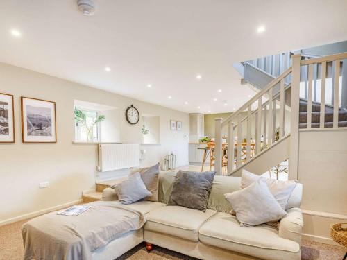 a living room with a couch and a staircase at 2 Bed in Llandrillo 88598 in Llandrillo