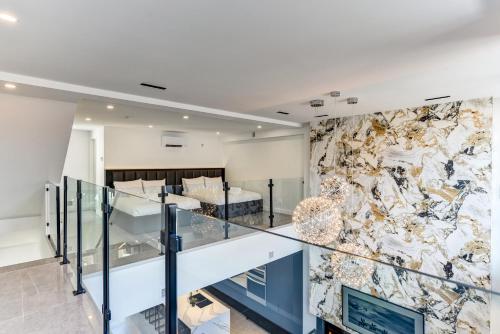 a room with a staircase and a stone wall at CLUBHAUS Hotel in Montréal