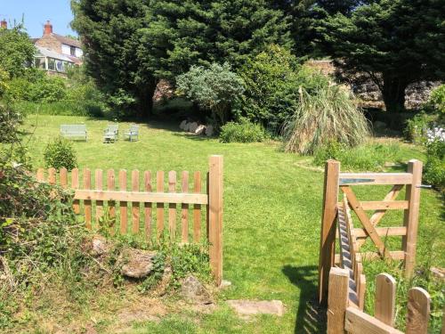 a wooden fence in a yard next to a field at 3 Bed in Fritchley 85797 in Crich