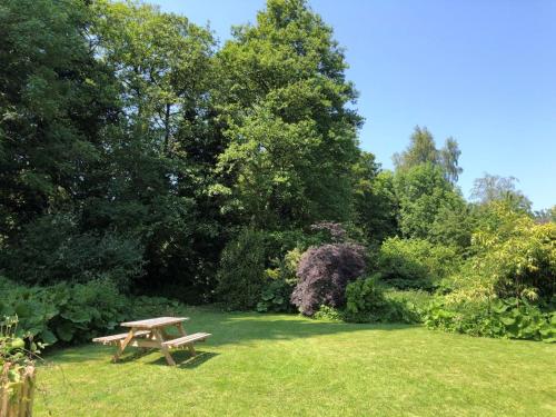 a picnic table in the grass in a garden at 3 Bed in Fritchley 85797 in Crich