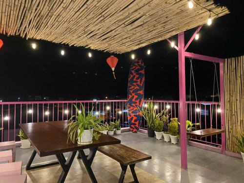 a room with a table and a red cross on a balcony at Homestay NAD nguyên căn tại Phan Thiết in Ấp Sung Xuân