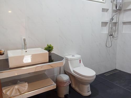 a white bathroom with a sink and a toilet at Jungle View Resort in Ko Chang