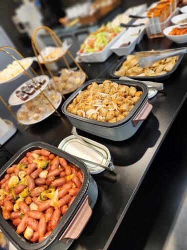 a buffet with many different dishes of food on a table at Workers Hotel Daejeon by Aank in Daejeon