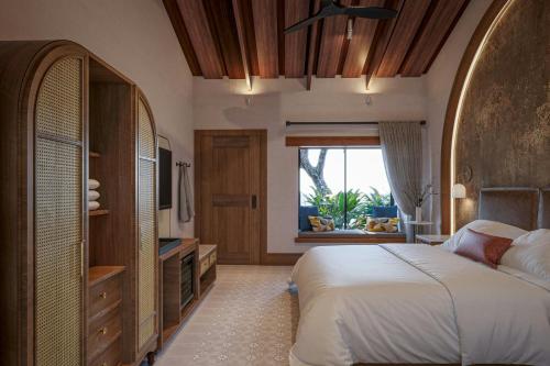 a bedroom with a bed and a large window at Santa Lucia Jungle Hacienda, Autograph Collection in Tarcoles