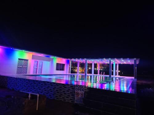 a building with colorful lights on it at night at Sea Smile Inn in Mandarmoni