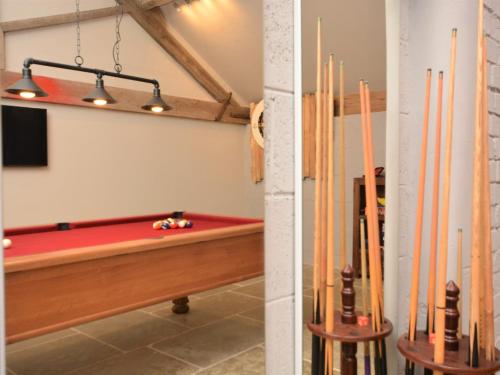 a pool room with a red pool table and pipes at 3 Bed in Melton Mowbray 61788 in Melton Mowbray
