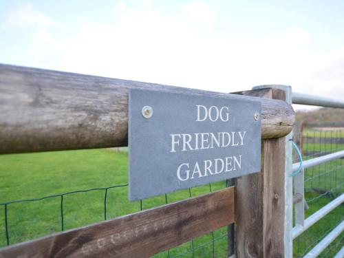 a sign for a dog friendly garden on a fence at 3 Bed in Melton Mowbray 61788 in Melton Mowbray