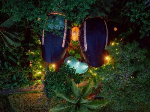 an overhead view of a garden with purple vegetables and lights at Hideout Eco Bamboo House Bali in Selat