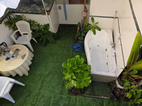 a bathroom with a bath tub and a table and chairs at Fehivilla resistance in Dhangethi