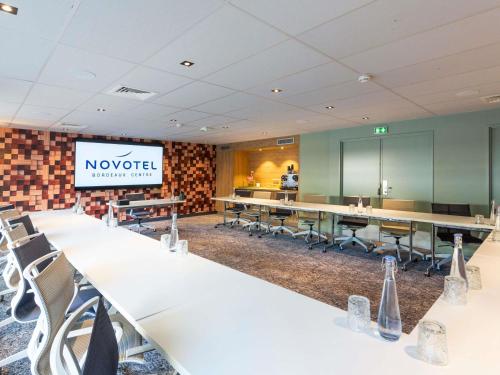 a conference room with white tables and chairs at Novotel Bordeaux Centre Ville in Bordeaux