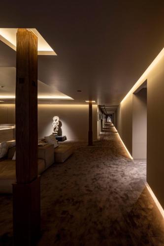 a living room with a couch and lights in a room at Momoyama Onsen Tsukimikan in Kyoto