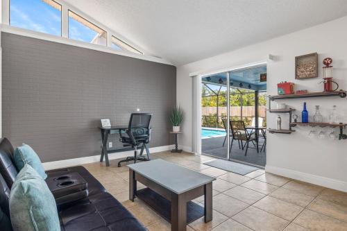 a living room with a couch and a table at Whole cozy house for group of 4 in Cape Coral