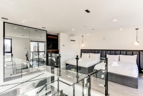 a bedroom with a bed and a glass balcony at CLUBHAUS Hotel in Montréal