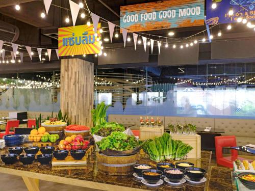 a food court with fruits and vegetables on a table at Novotel Bangkok on Siam Square in Bangkok