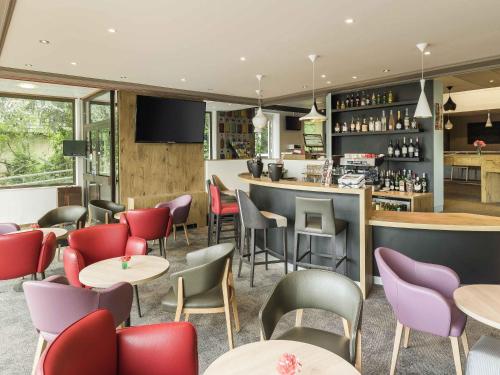 a restaurant with tables and chairs and a bar at ibis Colmar Est - Hotel Restaurant en Alsace in Colmar