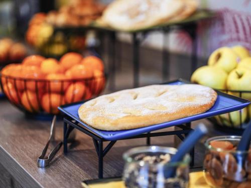a blue tray with a bread on a table with fruit at ibis Styles Perpignan Centre Gare in Perpignan