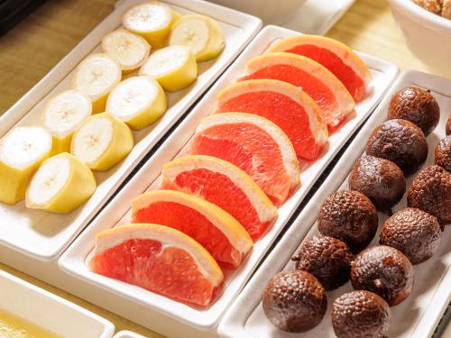 a tray filled with different types of fruit and pastries at Nishitetsu Resort Inn Naha in Naha